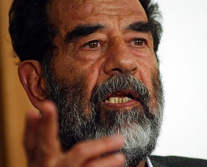 410px-Saddam_Hussein_at_trial,_July_2004-edit1