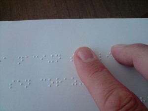 800px-A_person_reading_a_braille_book