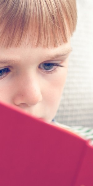 Young boy reading a book