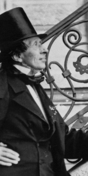 Hans Christian Andersen Posing Next to Stairway