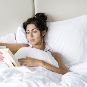 woman-reading-a-book-in-bed_1169-80
