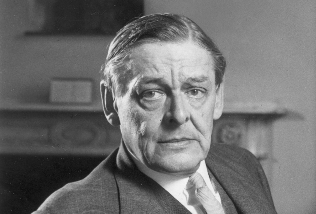 September 1958: Portrait of American-born poet TS Eliot (1888 - 1965) sitting with a book and reading eyeglasses, around the time of his seventieth birthday. (Photo by Express/Express/Getty Images)