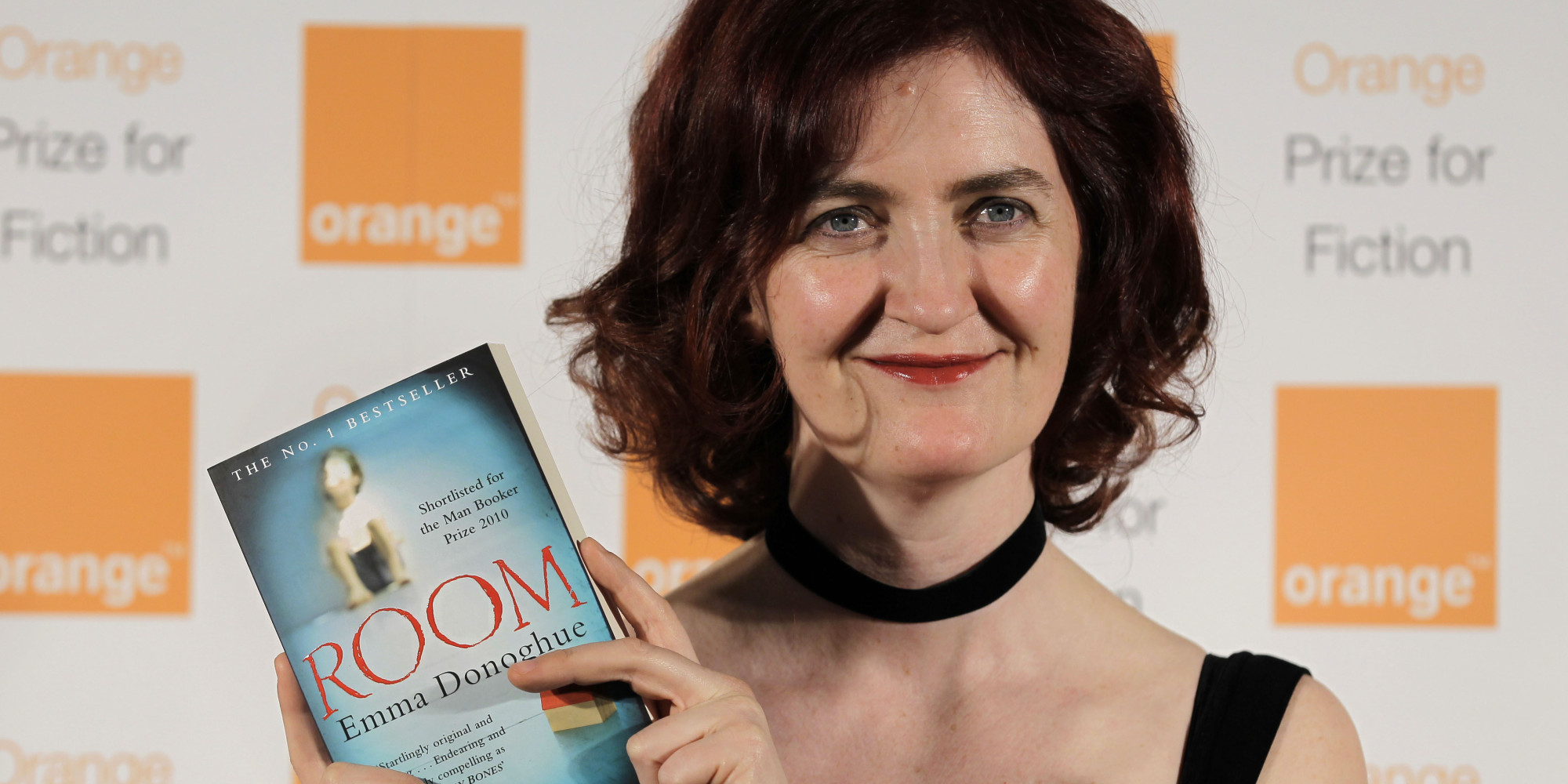 Shortlisted Irish author Emma Donoghue poses with her book 'Room' before the announcement of the 2011 Orange Prize for Fiction, during the awards ceremony at the Royal Festival Hall in London, Wednesday, June 8, 2011. (AP Photo/Sang Tan)