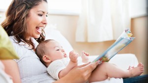 mother-reading-to-baby_TS_125172441