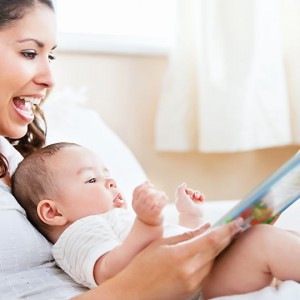 mother-reading-to-baby_TS_125172441