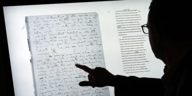 epa06054158 A man uses a touch screen to examine the manuscript 'The Trial' on a touch screen device and part of the exhibition 'Franz Kafka. The Whole Trial' in the Martin Gropius Bau, in Berlin, Germany, 28 June 2017. For the first time after it was written over 100 years ago the whole manuscript can be seen in Berlin. The idea for Kafka's famous work emerged from his conversation with his fiancee Felice Bauer about their engagement, something that the writer as a court session sensed.  EPA/FELIPE TRUEBA