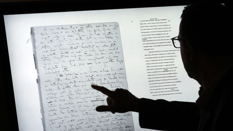 epa06054158 A man uses a touch screen to examine the manuscript 'The Trial' on a touch screen device and part of the exhibition 'Franz Kafka. The Whole Trial' in the Martin Gropius Bau, in Berlin, Germany, 28 June 2017. For the first time after it was written over 100 years ago the whole manuscript can be seen in Berlin. The idea for Kafka's famous work emerged from his conversation with his fiancee Felice Bauer about their engagement, something that the writer as a court session sensed. EPA/FELIPE TRUEBA