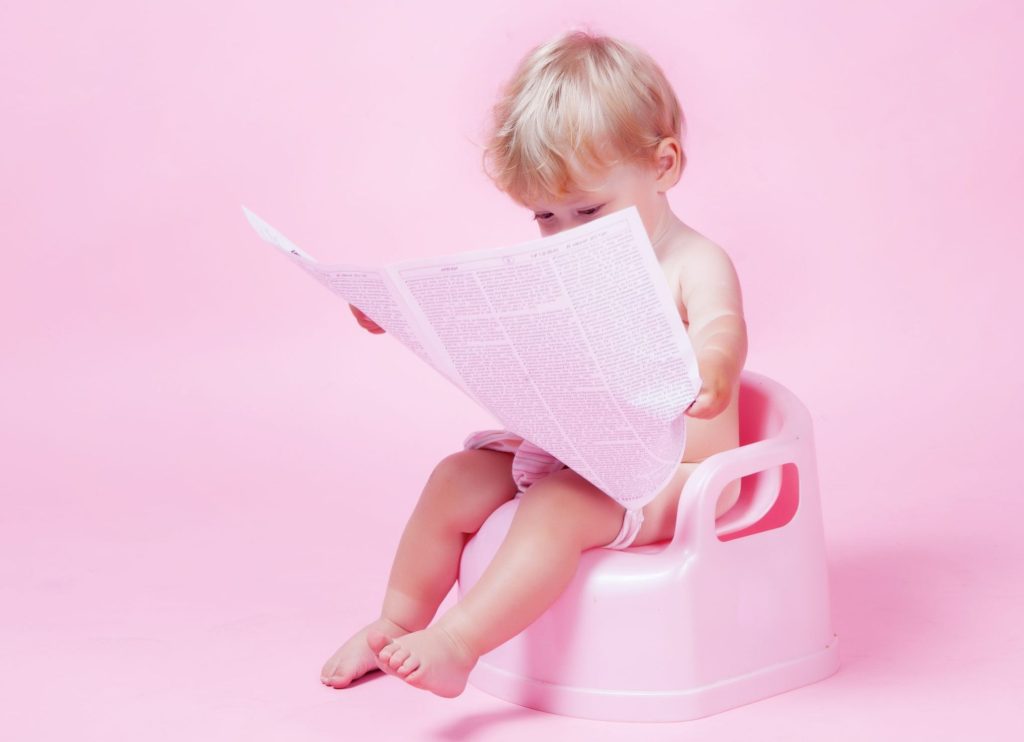 14055670 - little girl with newspaper on the pot