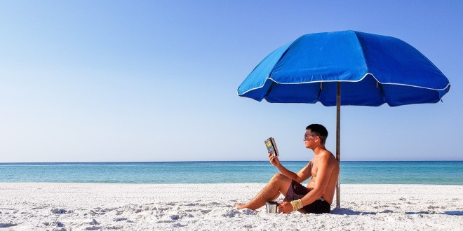 the-chairman-is-a-very-intellectual-guy-reading-a-paperback-book-under-his-beach-umbrella_t20_4lr2Ny