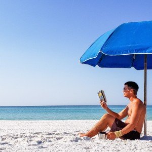 the-chairman-is-a-very-intellectual-guy-reading-a-paperback-book-under-his-beach-umbrella_t20_4lr2Ny