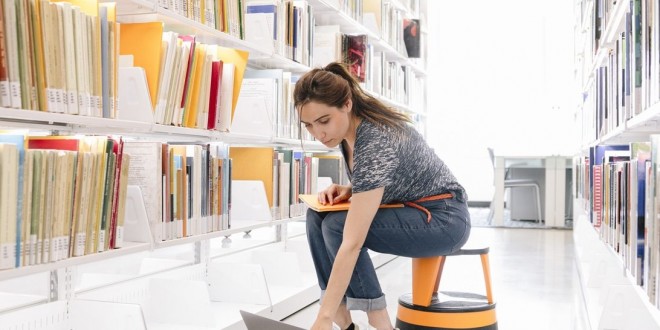 woman-working-on-a-laptop-in-a-library-galleries-libraries-and-museums