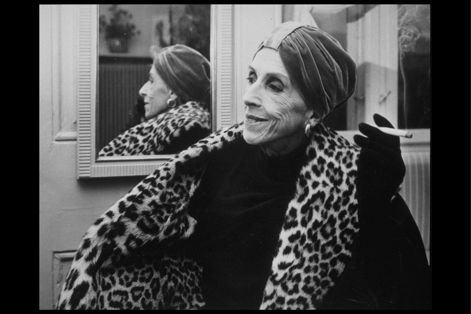 Baroness Karen Blixen (aka Danish writer Isak Dinesen) (1885 - 1962) stands in front of a mirror, wearing a velvet turban and leopard stole and holding a cigarette, January 2, 1958. (Photo by Getty Images)